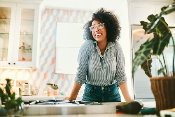 Woman wearing glasses by sink